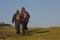 A couple hiking across the countryside