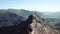 Couple hiking along a knife edge ridge up mount Snowdonia in Wales, UK