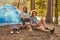 Couple hiking at in the forest. Attractive couple warming near a campfire at camp.