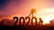 Couple hiking help each other silhouette in 2020 new year