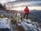 Couple hiking photographers on view point above forest