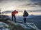 Couple hiking photographers on view point above forest