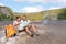 Couple hiking on volcano on Hawaii looking at map