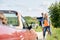 Couple hitchhiking and stopping car on countryside