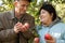 Couple hold apples and look against each other