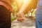 Couple hold hands in the autumn or summer park on sunset. Closeup of loving couple holding hands while walking