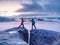 Couple hold light  above danger gulch between rocks