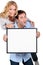Couple holding blank message board