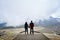 Couple holding hands on an abandoned cableway platform building social distancing beautiful landscape in Serra da Estrela,