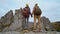 Couple holding hands hiking outdoors at romantic view on rocky national park Tustan, Ukraine. Hikers man and woman