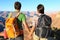 Couple holding hands looking at Grand Canyon