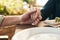 Couple, holding hands and lunch with praying, love and trust in marriage, hope and care at table outdoor. Man, woman and