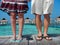 Couple holding hands and standing on a dock in the Maldives, South Asia