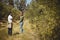 Couple holding hands while standing at olive farm