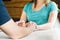 Couple holding hands on table together. Support, help, caring, forgiveness or apology.