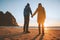 Couple holding hands walking on Kvalvika beach travel lifestyle romantic vacations honeymoon trip