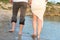 Couple holding hands walking romantic on beach on vacation travel holidays