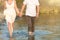 Couple holding hands walking romantic on beach on vacation travel holidays