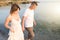 Couple holding hands walking romantic on beach on vacation travel holidays