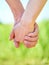 Couple holding hands and walking in sunny summer weather