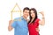 Couple holding tape measure in form of house and key