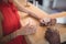 Couple holding their hands while having whisky at counter