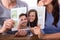 Couple Holding Torn Photograph