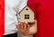 Couple holding a toy house model in hands