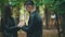 Couple is holding and warming up hands with hot beverages, during cold autumn day. Close up. Blurred background. Crop