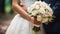 couple holding wedding flowers background