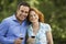 Couple Holding Wine Glasses In Park