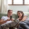 Couple at home on the couch with a mobile phone