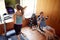 Couple In Home Gym Exercising With Weights And Using Running Machine