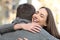 Couple hugging after happy proposal in the street