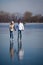 Couple ice skating outdoors on a pond