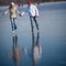 Couple ice skating outdoors on a pond