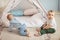 Couple infant boys of 1-year old playing in toy tent with garland at nursery.