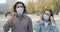 Couple inhaling fresh air on removing protective face mask