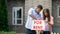 Couple installing for rent signboard, family needs additional income, crisis