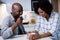 Couple interacting with each other while having coffee in kitchen