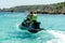 Couple on jetski around the crystal water. Adventure