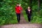 Couple jogging on dirt path in the woods