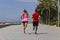 Couple jogging running outside on seafront promenade near the sea.Athletic couple concept .Sport and healthy lifestyle idea