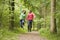 Couple jumping on path holding hands and smiling