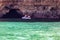 A couple in a kayak in benagil caves over turquoise waters