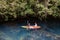 couple kayak in jungle of Krabi Thailand, men and woman kayak in tropical jungle mangrove forest.