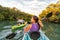 Couple kayaking together in mangrove river of the Keys, Florida, USA. Tourists kayakers touring the river of Islamorada