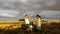 Couple with kids stand in a wheat field and pop air balloon to know the gender of future baby