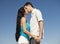 Couple kissing on blue sky background