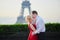 Couple kissing in front of the Eiffel tower in Paris, France